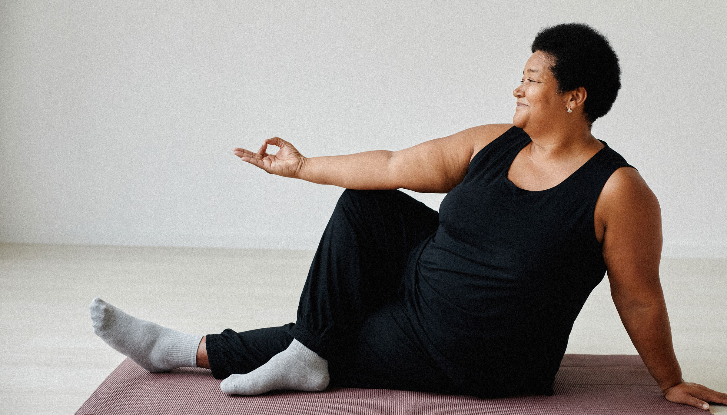 Overweight woman exercising and smiling contentedly